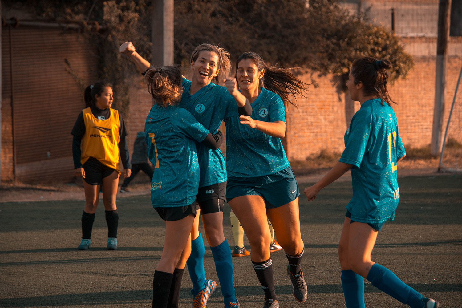 A high school team celebrating a victory together on the field